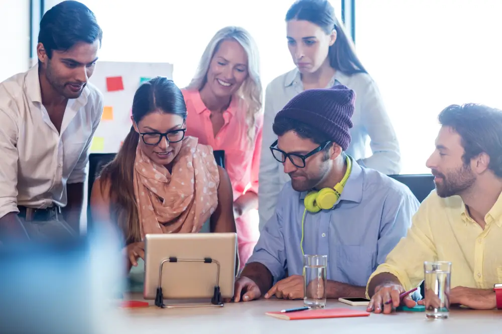 group coworkers using tablet computer