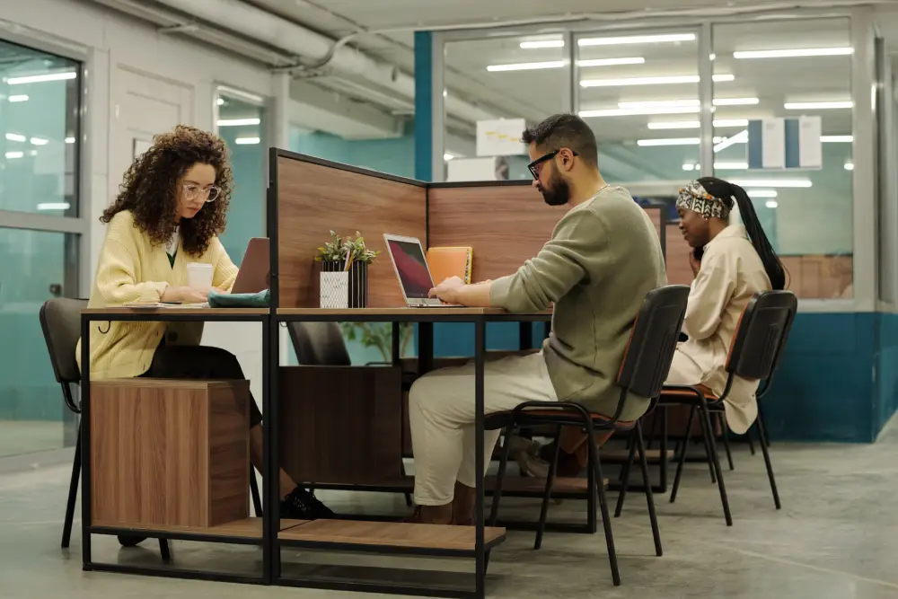 group of young intercultural coworkers sitting by their workplaces office