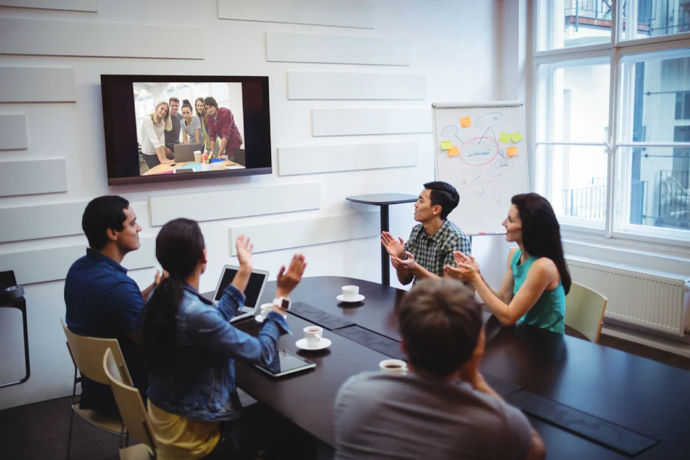 business executive applauding video conference