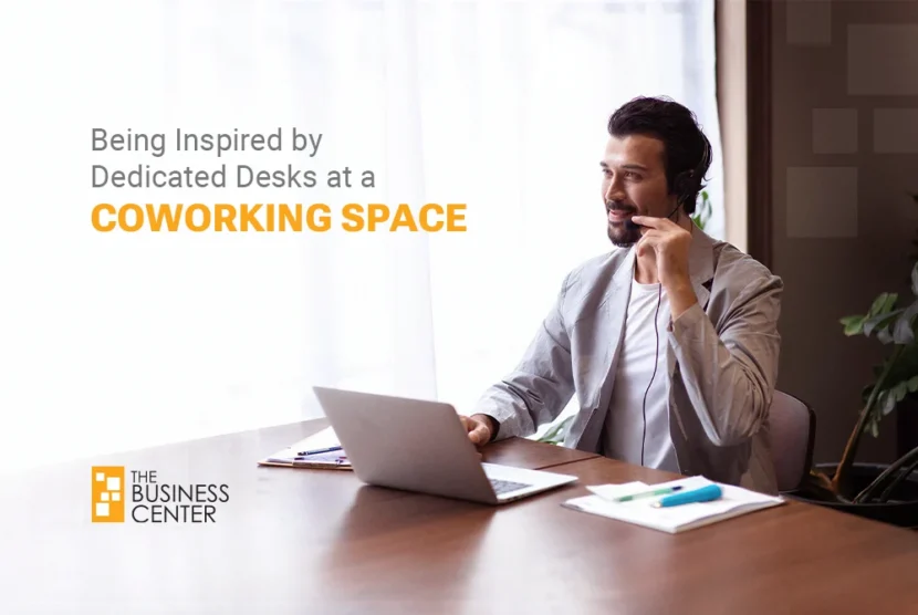 Smiling professional man using a headset at his laptop, experiencing dedicated workstation productivity at a premium coworking space in Dhaka.